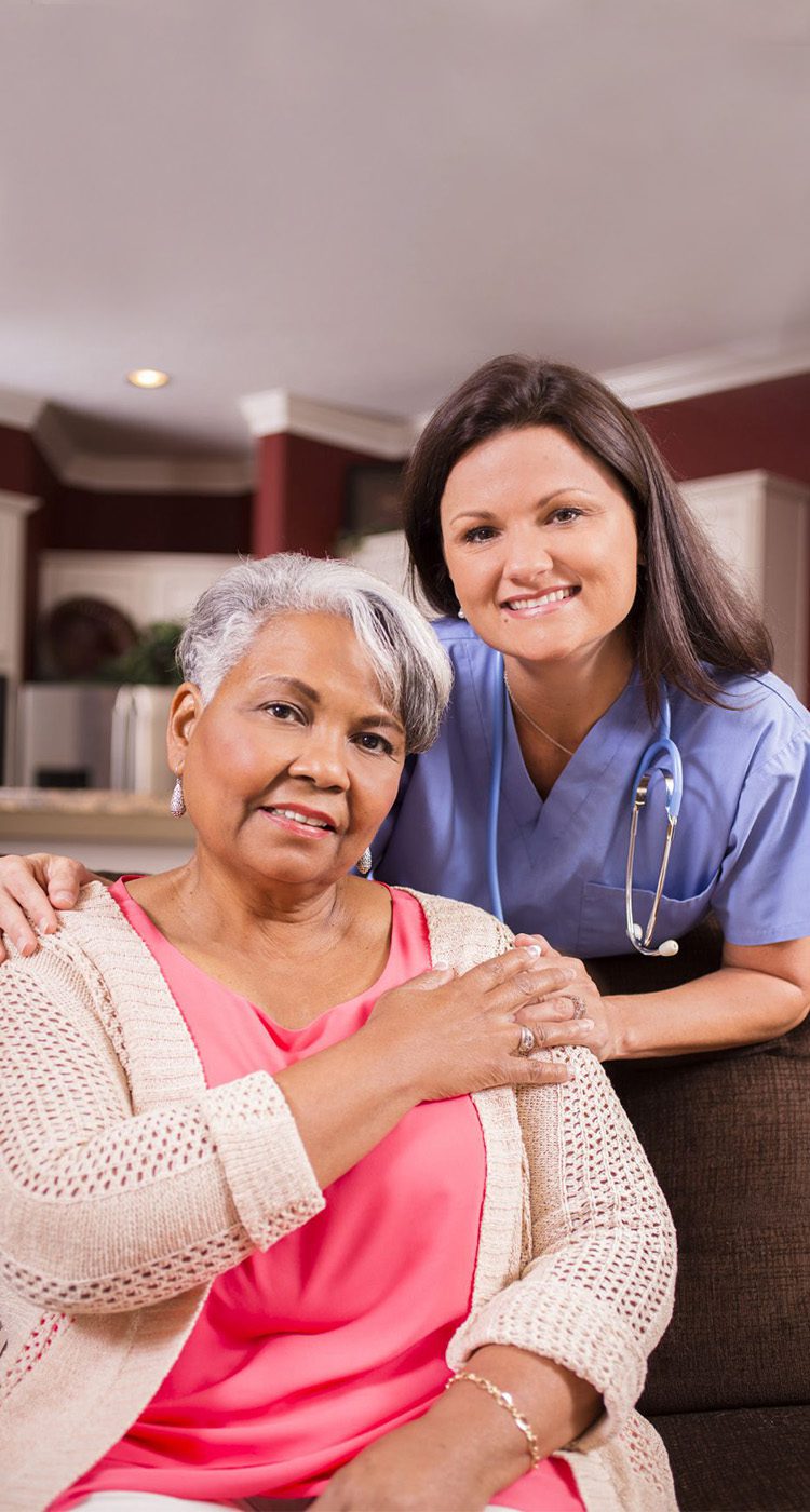 Home nurse with smiling senior woman
